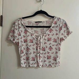 SHEIN white crop top with red and black flowers, ruffles, and tie/hole. Size S.
